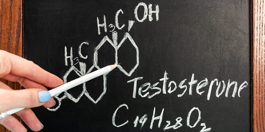 Cropped View Of Woman Holding Pencil Near Blackboard With Testos